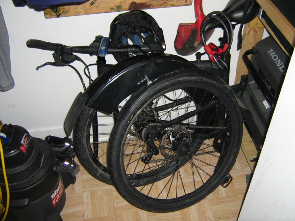 Bicycle folded in closet.