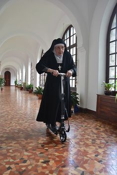 Nun on a scooter.