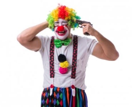 A clown holding a gun to his own head.