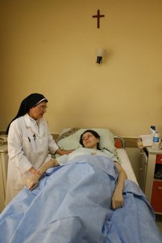 Nun at a patient's bedside.